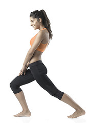 Image showing fit woman stretching on white