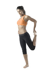 Image showing fit woman stretching on white