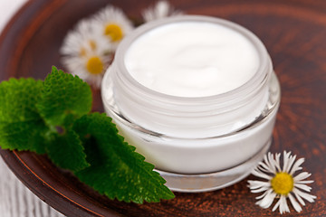 Image showing container with cream urtica and chamomiles