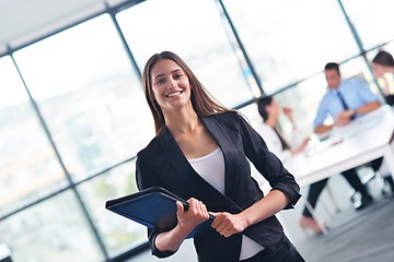 Image showing business woman with her staff in background at office