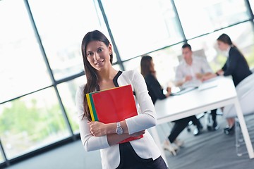 Image showing business woman with her staff in background at office