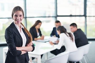 Image showing business woman with her staff in background at office