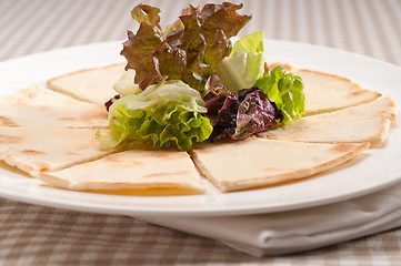 Image showing garlic pita bread pizza with salad on top