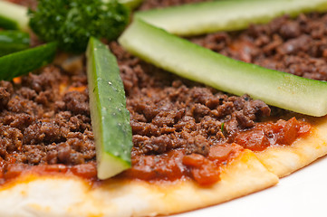 Image showing Turkish beef pizza with cucumber on top