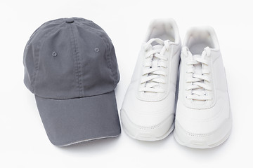 Image showing Running shoes and baseball cap