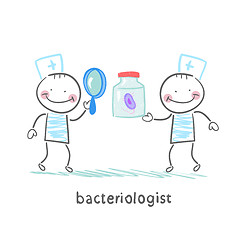 Image showing bacteriologist looking through a magnifying glass on the bacteri