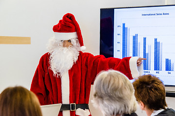 Image showing Female Santa Claus presenting in business meeting