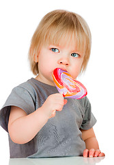 Image showing Baby eating a sticky lollipop