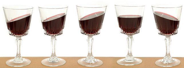 Image showing Five wineglasses on a line