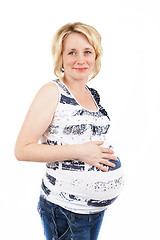 Image showing beautiful pregnant woman tenderly holding her tummy isolated on white background