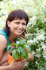 Image showing happy smiling middle age woman gardening