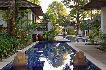 Image showing pool with palm trees in an exotic hotel