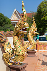 Image showing Thai golden dragon guards the entrance to the temple