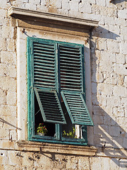 Image showing old mediterranean window with green shutters