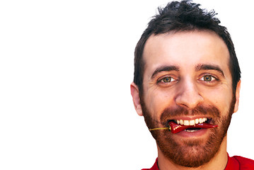 Image showing man with a red hot chili pepper in his mouth