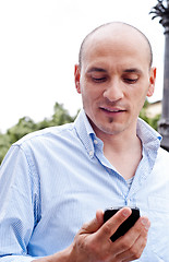 Image showing businessman talking on cellphone outdoors