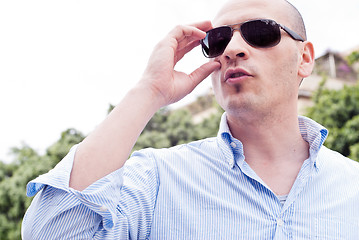Image showing portrait of a attractive gorgeous guy wearing sunglasses