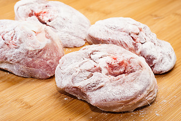 Image showing ossobuco floury on wooden board