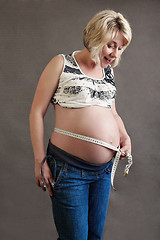 Image showing beautiful pregnant woman tenderly measuring her tummy