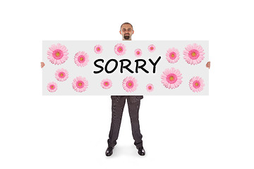 Image showing Smiling businessman holding a really big card