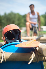 Image showing Helmet and oar on inflatable raft