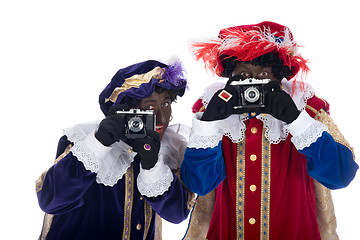 Image showing Zwarte Piet and his co-worker are taking photographs