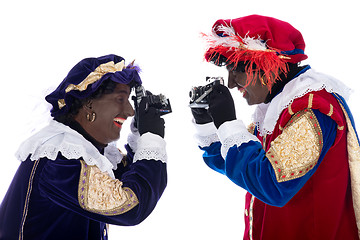 Image showing Zwarte Piet and his co-worker are taking photographs