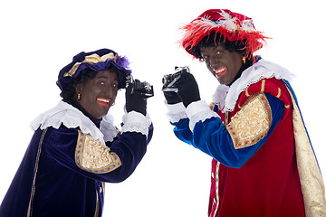 Image showing Zwarte Piet and his co-worker are taking photographs