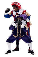 Image showing Zwarte Piet and his co-worker are taking photographs