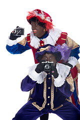 Image showing Zwarte Piet and his co-worker are taking photographs