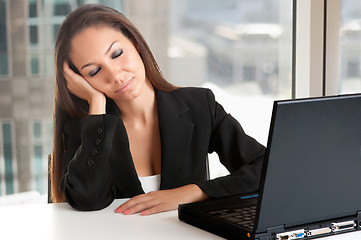 Image showing Businesswoman Sitting at Her Desk Sleeping