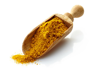 Image showing wooden scoop with curry powder