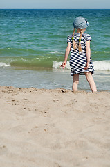 Image showing Small girl on sand beach
