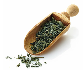 Image showing wooden scoop with dried green tea