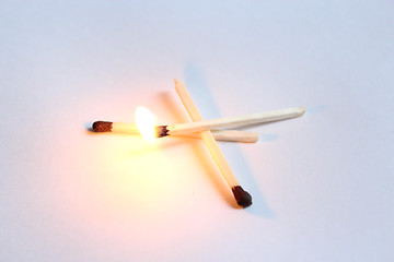 Image showing match blazing above others