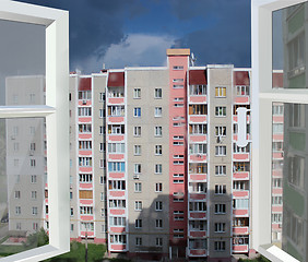 Image showing opened window to multistorey house and raincloud