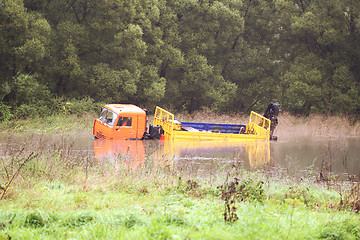 Image showing A large truck was drowned in the river water