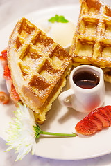 Image showing Baked waffles with syrup and strawberries