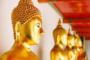 Image showing Golden Buddha in a row