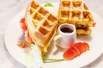 Image showing Waffles with syrup and strawberries