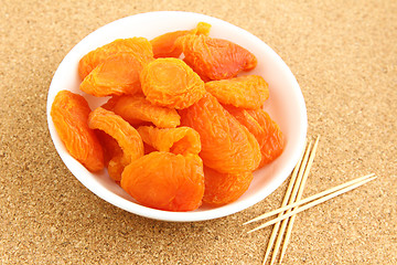 Image showing Dried apricots with toothpick