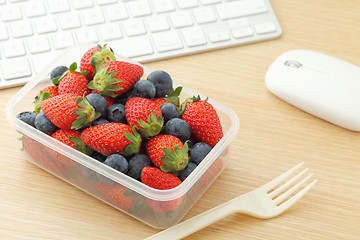 Image showing Berry mix lunch box in working desk