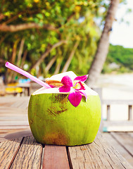 Image showing Coconut drink on table beside beach
