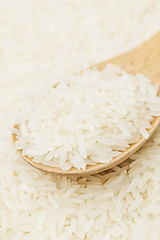 Image showing Uncooked white rice on spoon