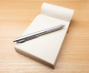 Image showing Memo pad and pen on the table