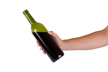 Image showing Hand holding a bottle of red wine