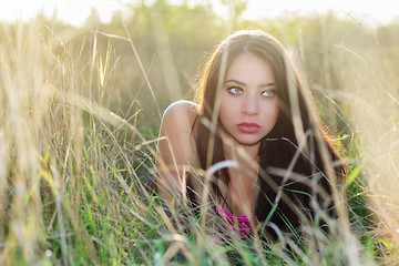 Image showing Young brunette hiding