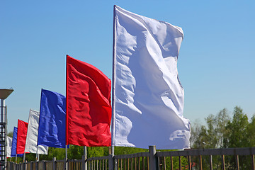 Image showing colored flags on a blue sky background