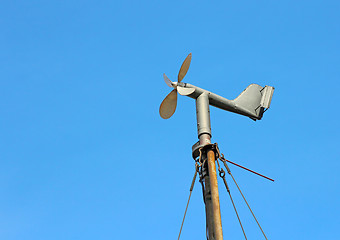 Image showing Vintage wind mill the background of blue sky