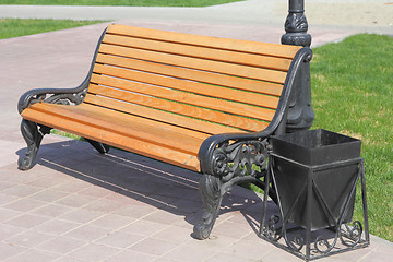 Image showing wooden bench with an urn